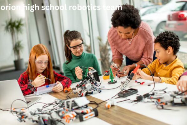 Lake Orion High School Robotics Team showcasing their robot during a competition.